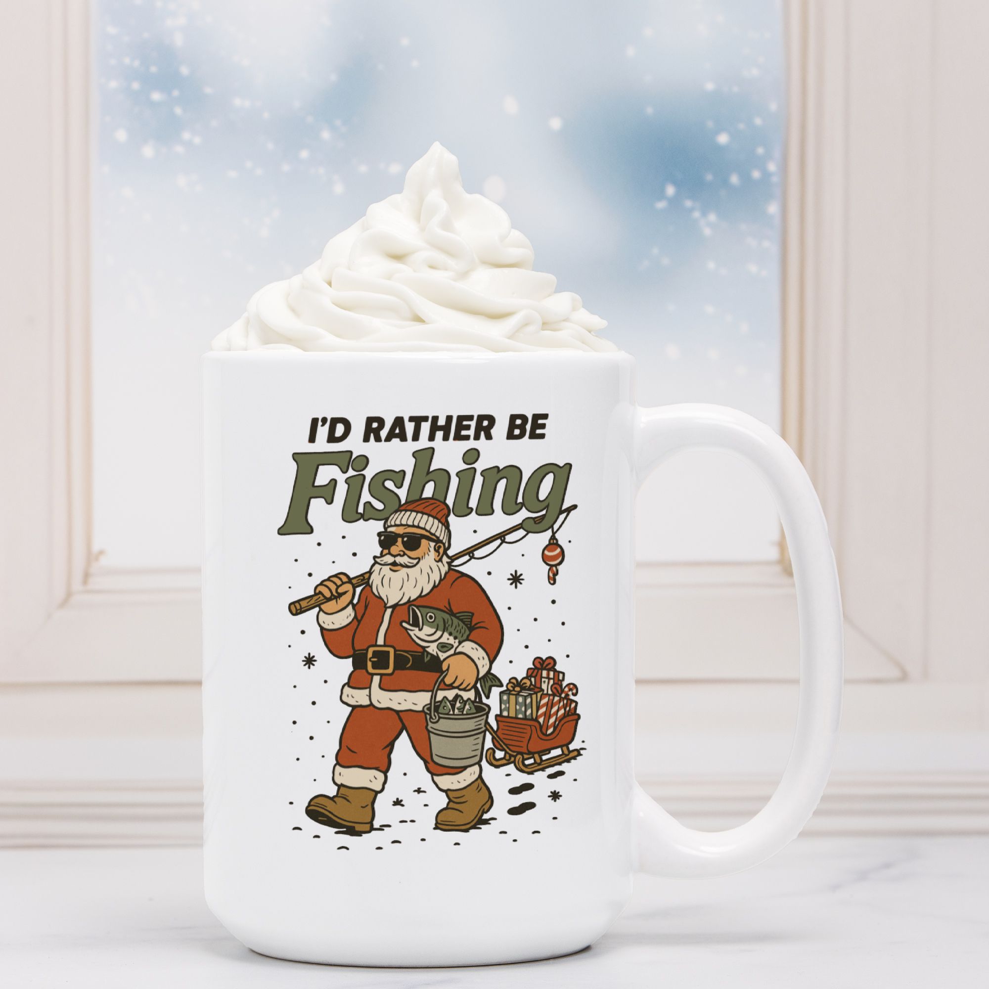 White mug with a Santa Claus graphic and 'I'd Rather Be Fishing' text, filled with hot chocolate.