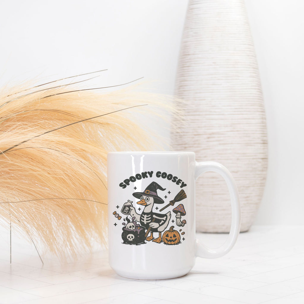 White mug with Halloween-themed design featuring a skeleton goose, pumpkins, and text on a white background.