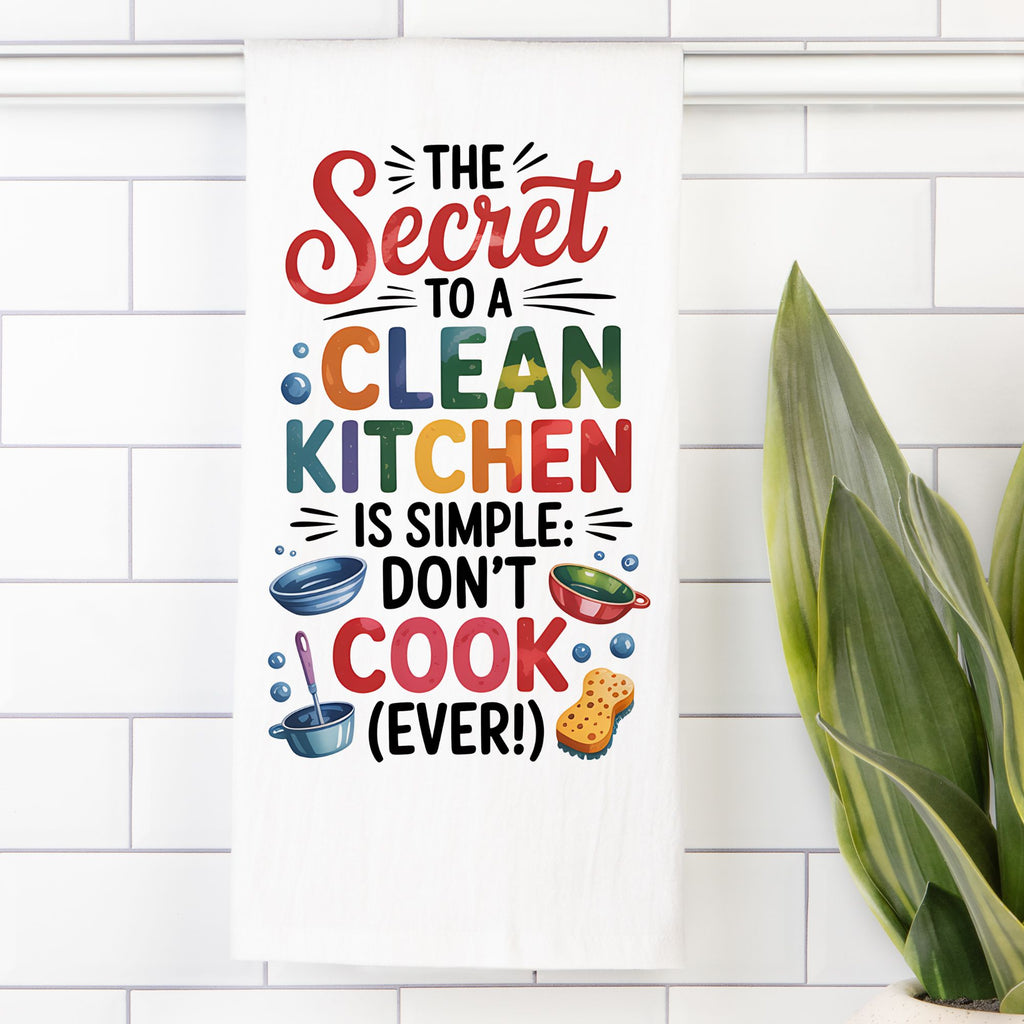Colorful kitchen towel with humorous quote on a white tiled wall.