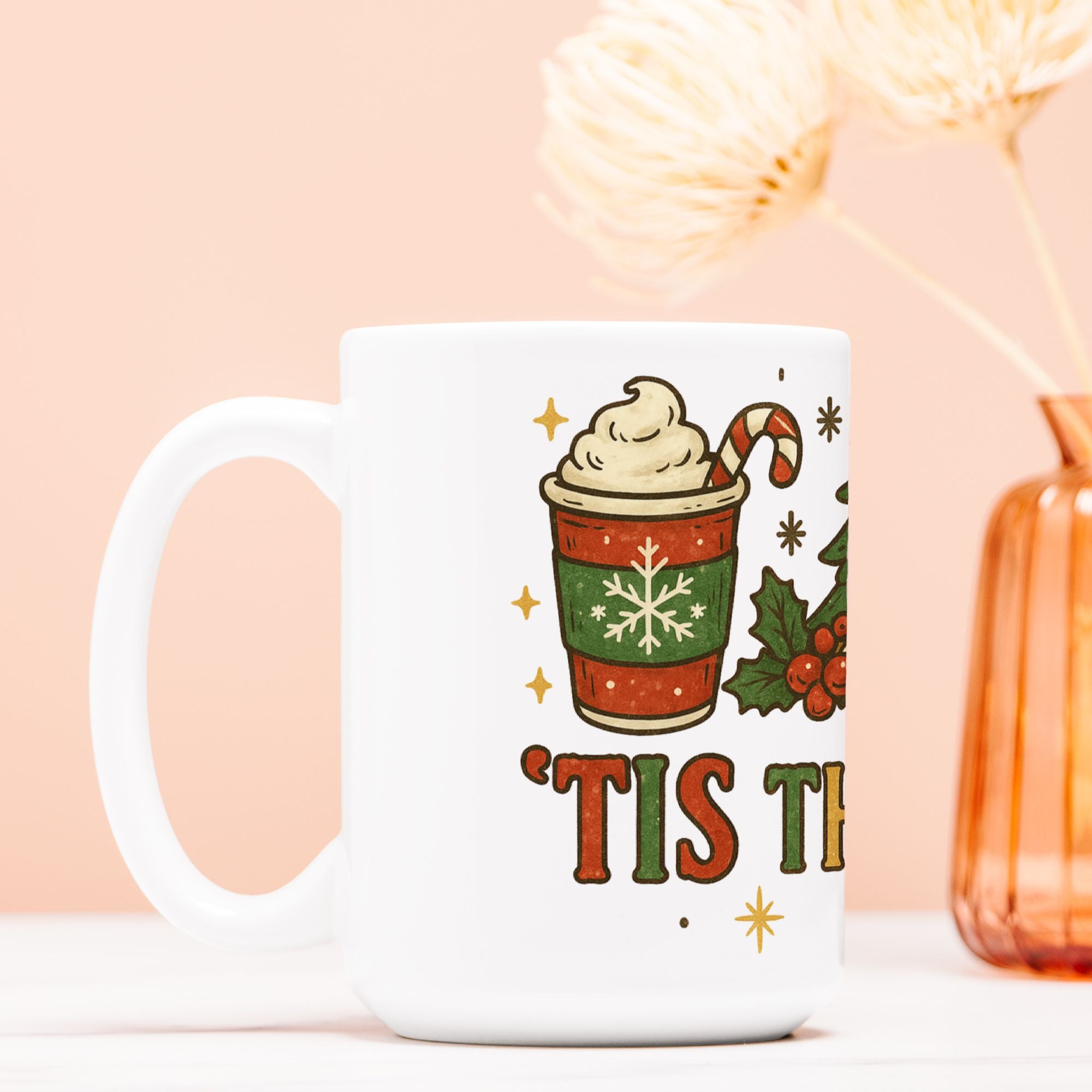 White mug with Christmas-themed design featuring a cup of hot chocolate and text on a light pink background.