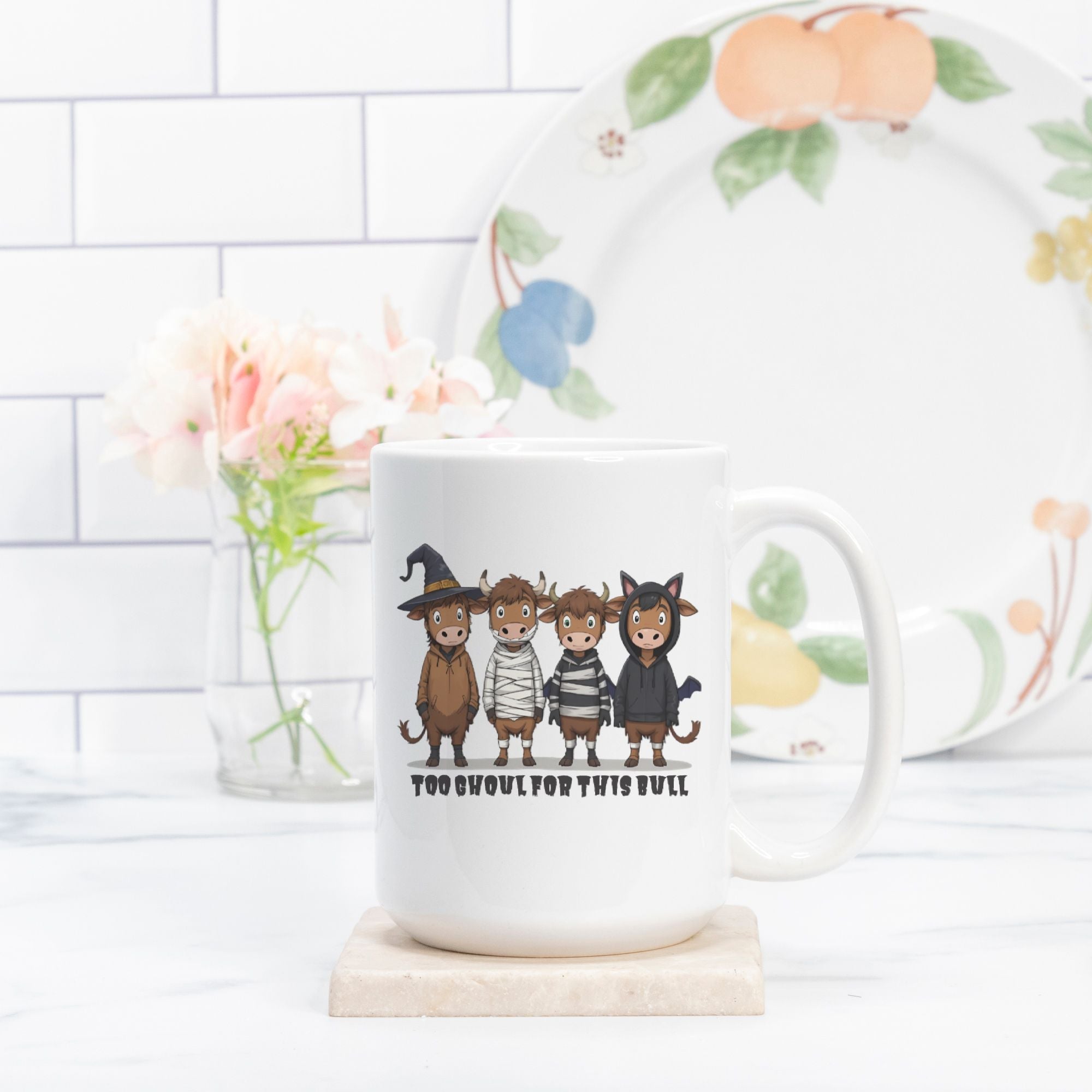 White mug with cartoon animal costumes and text on a white surface with a decorative plate in the background.