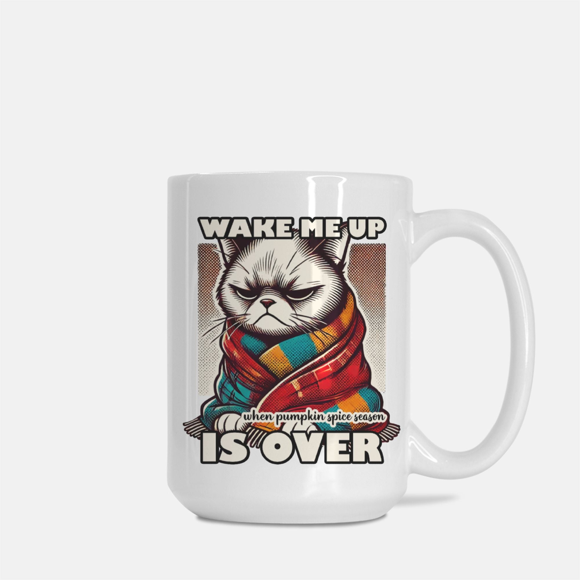 White mug with a cat wearing a colorful scarf and text 'Wake me up when pumpkin spice season is over' on a white background
