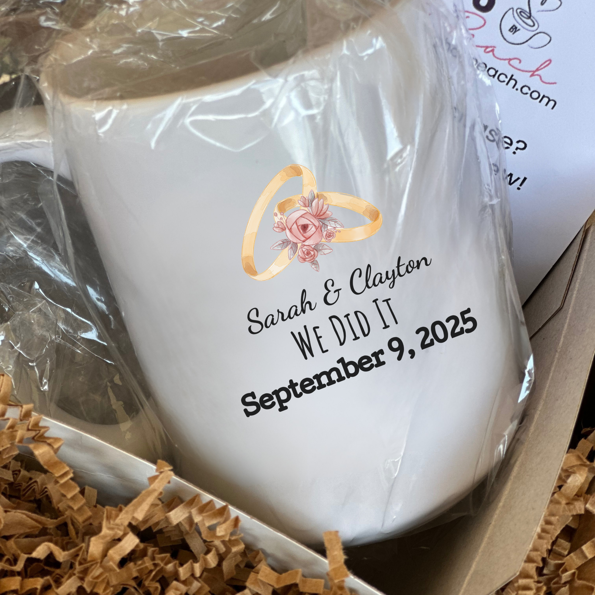 White mug with personalized text and ring design in a box with brown tissue paper