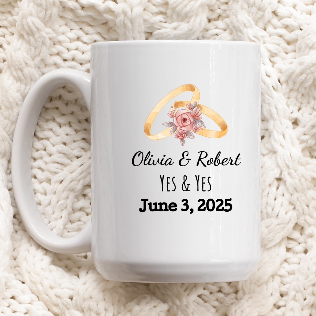 White mug with wedding rings and personalized text on a white textured background