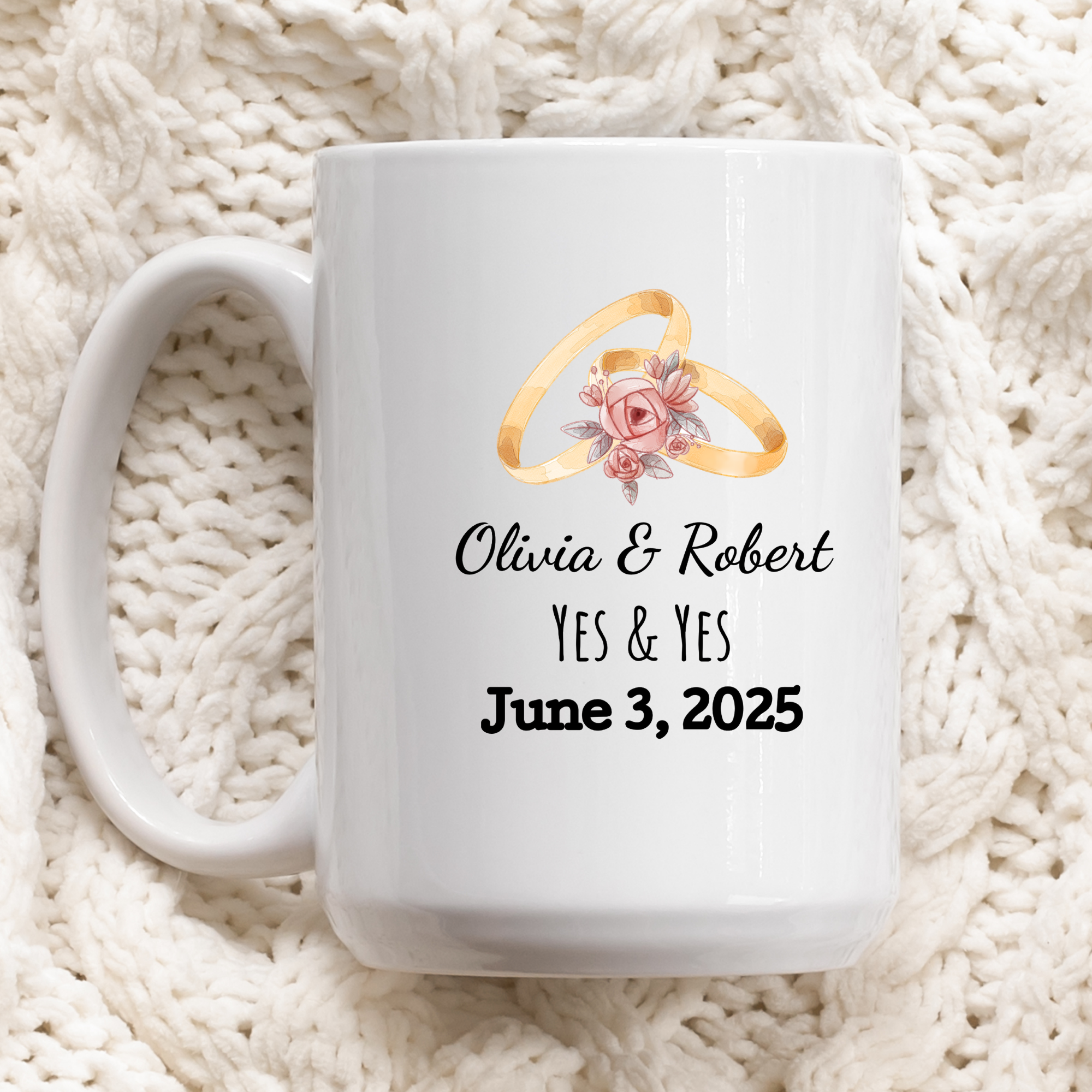 White mug with wedding rings and personalized text on a white textured background