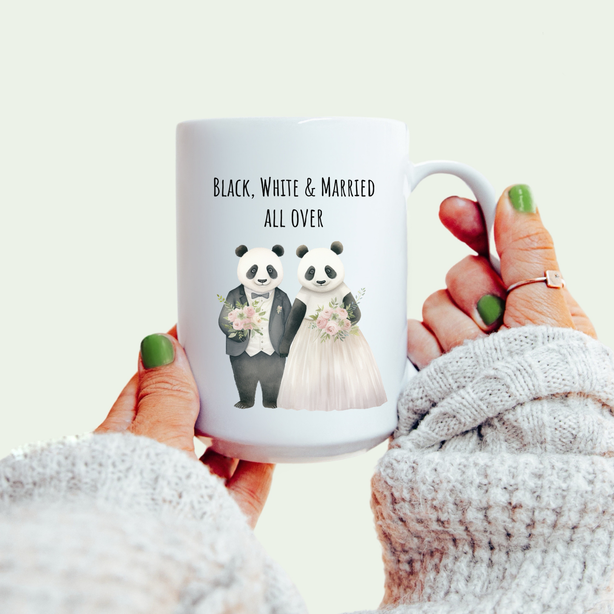 Mug with panda couple design and text 'Black, White & Married All Over' held by a person.