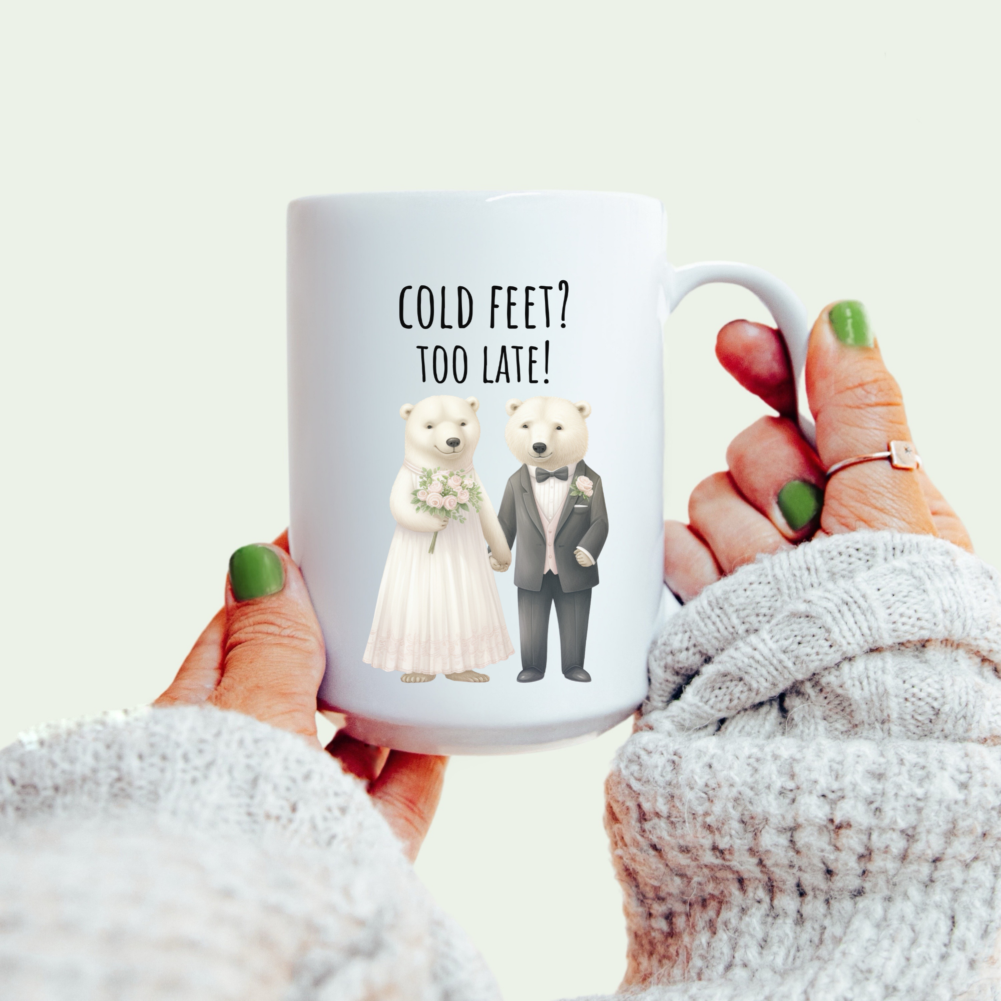 Mug with cartoon bears and text 'Cold Feet? Too Late!' held by a person wearing a white sweater.