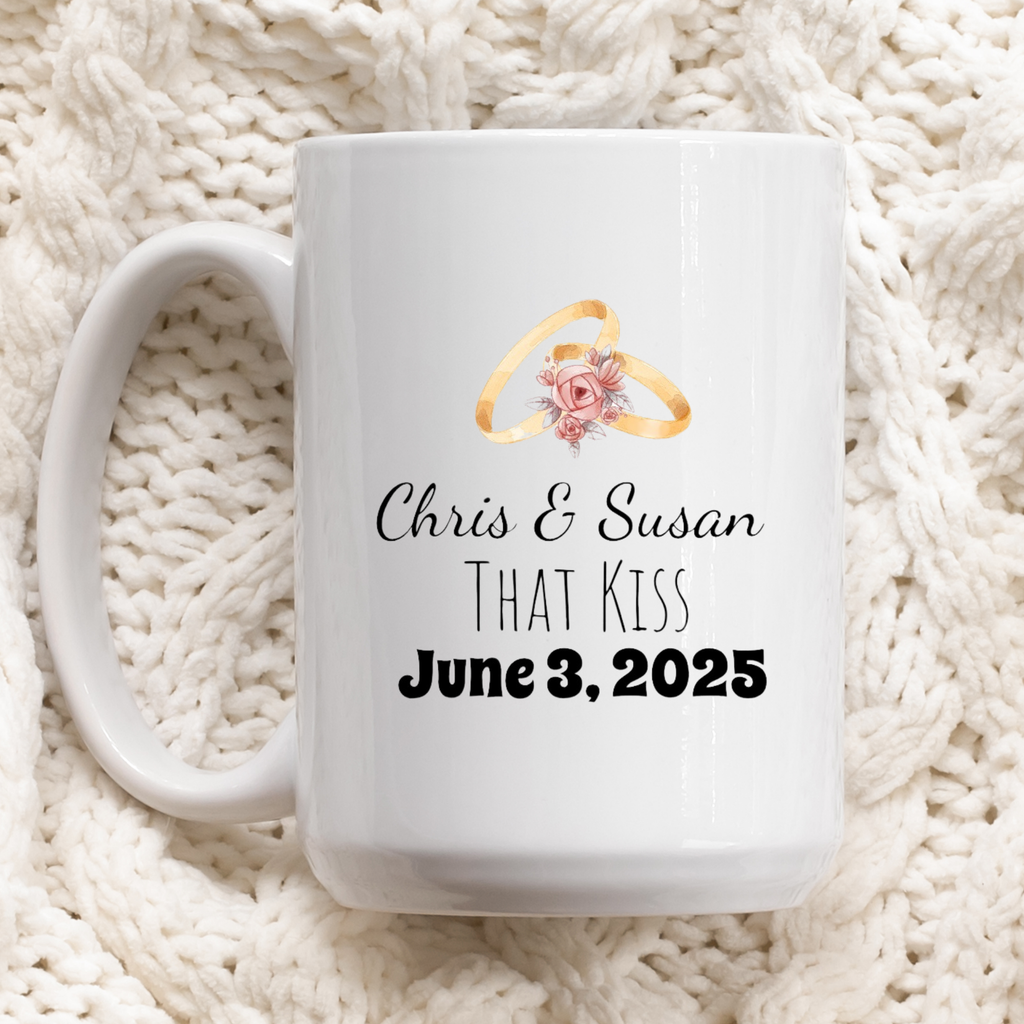 White mug with personalized design of wedding rings and text on a white textured background