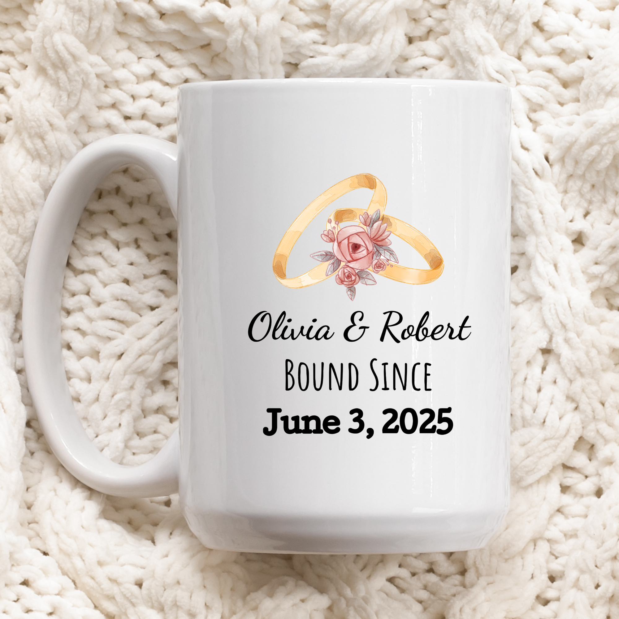 White mug with wedding rings design and personalized text on a white textured background