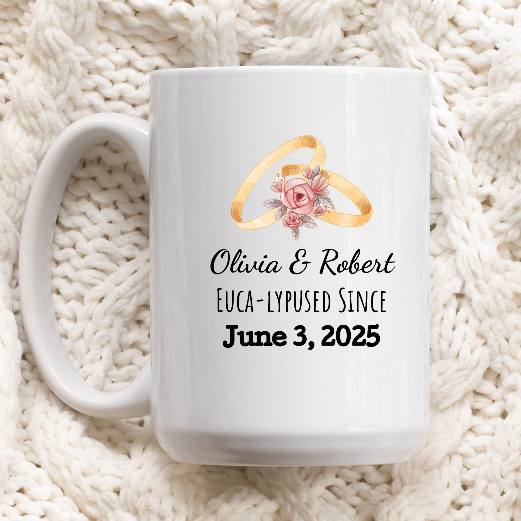 White mug with wedding rings and personalized text on a white textured background
