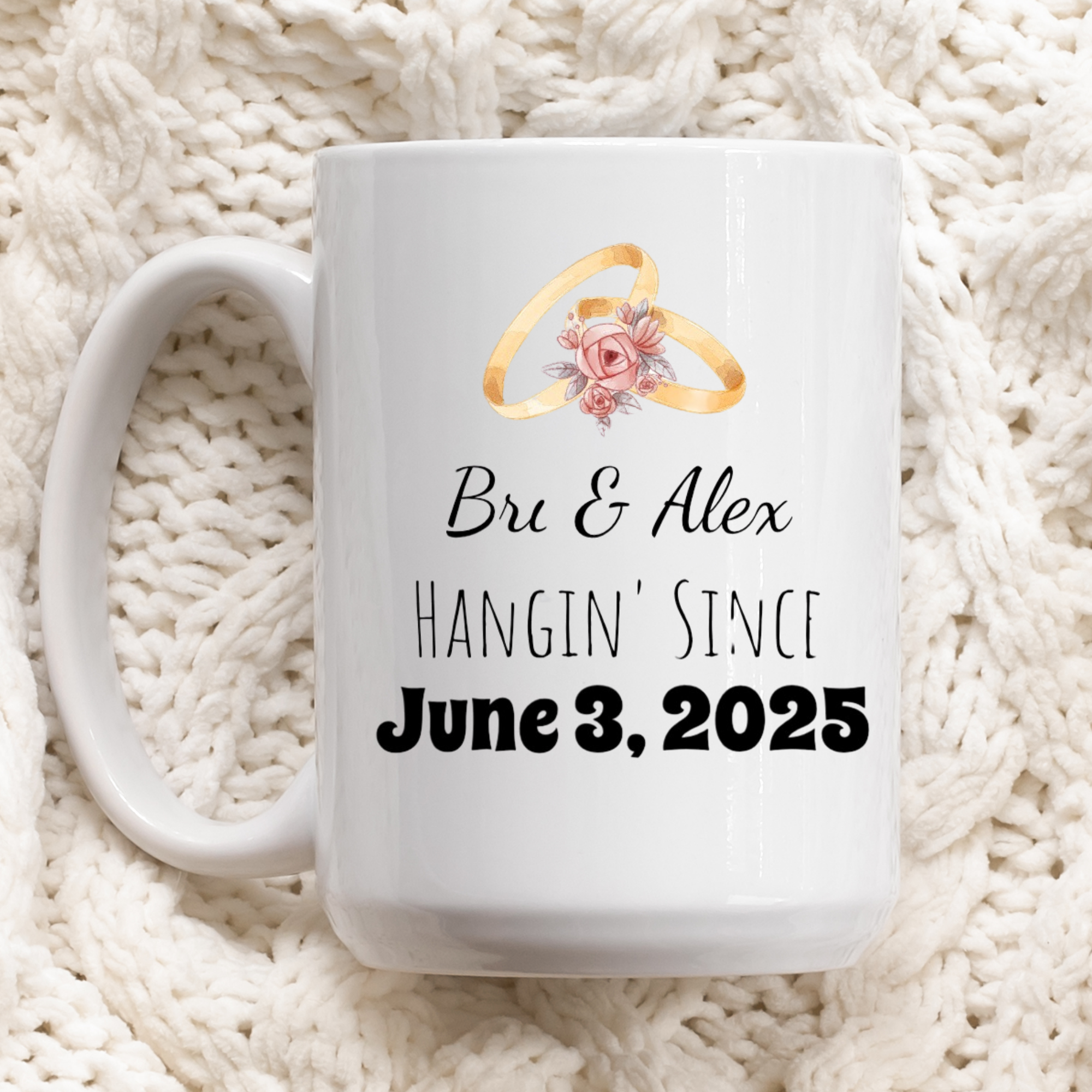 White mug with wedding rings and text on a white textured background