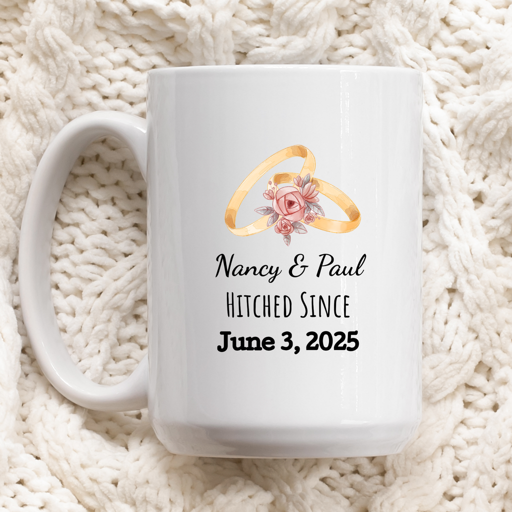 White mug with wedding rings design and personalized text on a white textured background