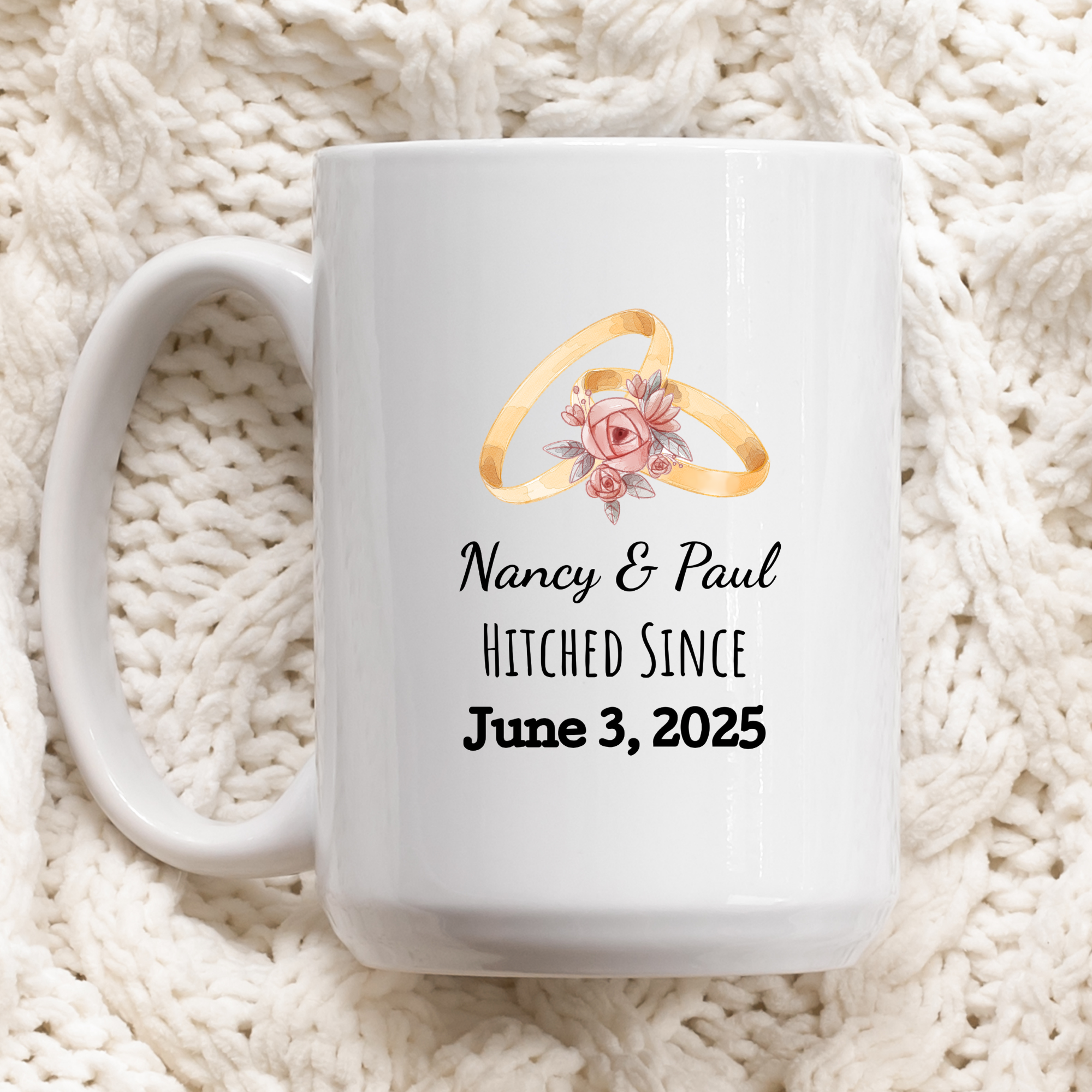 White mug with wedding rings design and personalized text on a white textured background