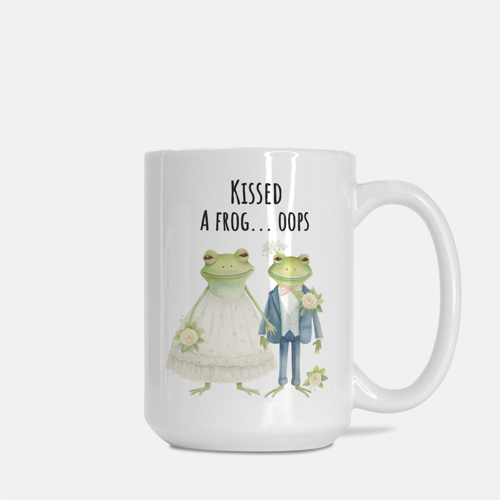 Mug with frogs in wedding attire and text 'Kissed a frog... oops' on a white background