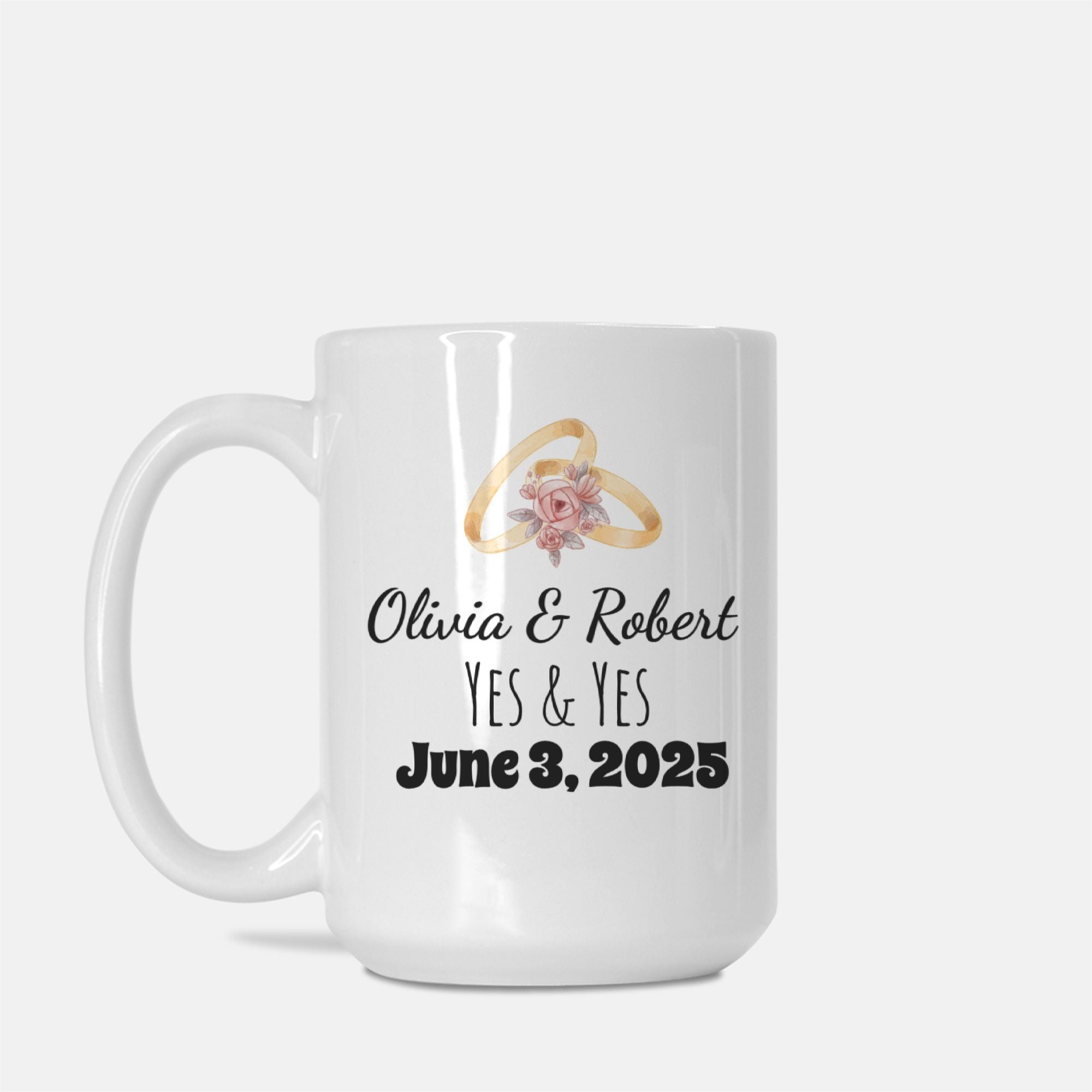 White mug with wedding rings and floral design, personalized with names and date.